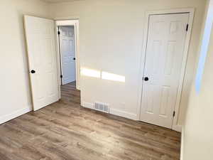 Unfurnished bedroom with light wood-type flooring and baseboards