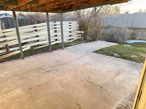 View of patio with a storage unit