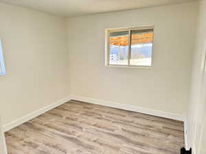 Empty room featuring light wood-style floors and baseboards