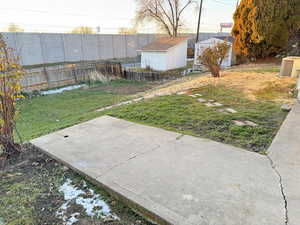 Fenced backyard with a patio
