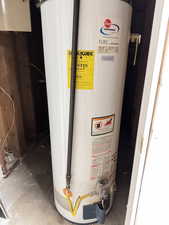 Utility room featuring water heater