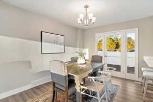 Dining room featuring wood finished floors and a chandelier