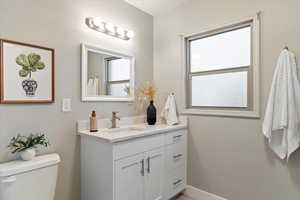 Bathroom featuring vanity and healthy amount of natural light