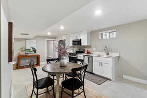 Dining room featuring a textured ceiling, recessed lighting, and light tile patterned floors