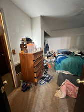 Bedroom with a textured wall and a ceiling fan