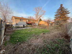 Back of property featuring a fenced backyard, a patio, stairway, and a chimney