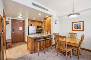 Dining area featuring light colored carpet, light tile patterned floors, and recessed lighting