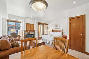 Bedroom with a tile fireplace, carpet flooring, and recessed lighting