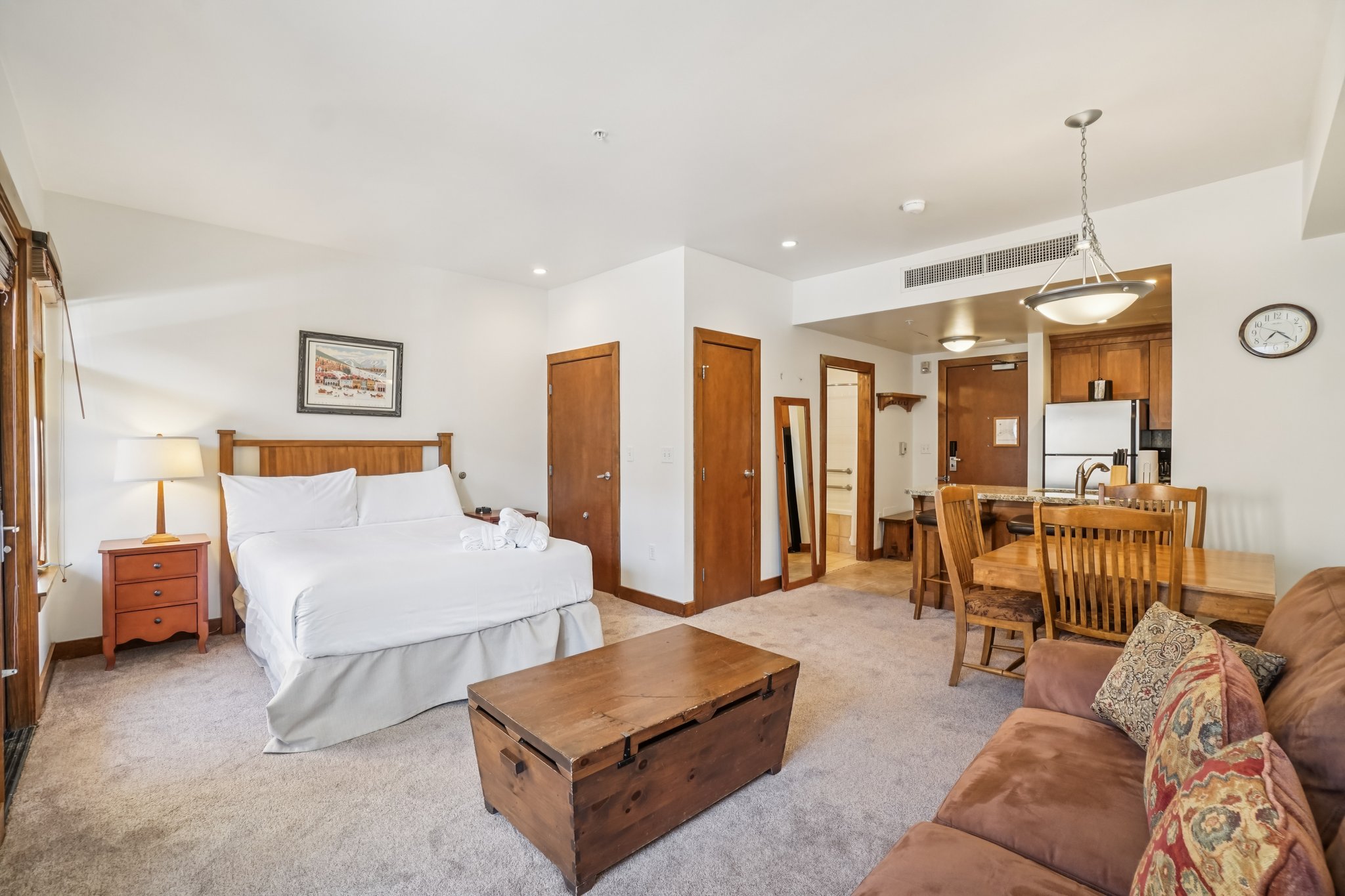 Bedroom featuring two closets, carpet floors, and freestanding refrigerator