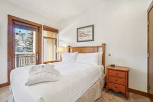 Bedroom featuring carpet flooring and access to exterior