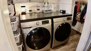 Washroom featuring independent washer and dryer and LVP finished floors