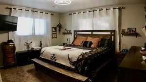 Bedroom with dark colored carpet