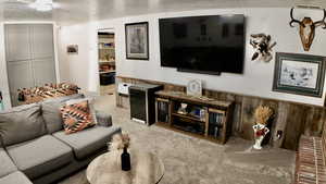 Carpeted living room featuring a textured ceiling