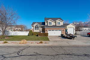 View of front of house featuring driveway, roof with shingles, and brick siding