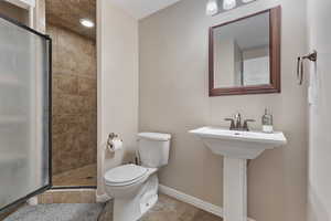 Full bath with a shower stall and toilet