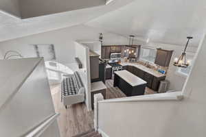 Kitchen featuring a center island, decorative light fixtures, light countertops, a chandelier, and a textured ceiling