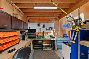 Miscellaneous room featuring concrete floors and a workshop area