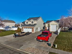 Traditional home with a trampoline and concrete driveway