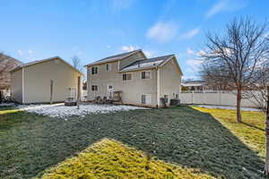 Rear view of house featuring a patio area and a fenced backyard