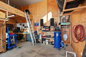 Garage with wood walls and a workshop area