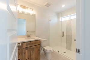 Full bathroom featuring vanity, a stall shower, and light tile patterned floors