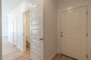 Hall featuring light wood-type flooring and baseboards