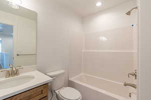Bathroom with vanity, tub / shower combination, and recessed lighting