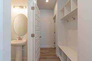 Mudroom with wood finished floors and baseboards