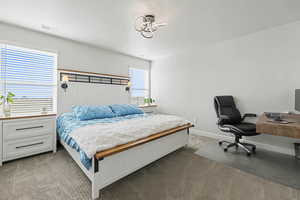 Bedroom featuring carpet floors and an office area