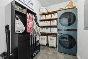 Laundry area with estacked washer and dryer and electric panel
