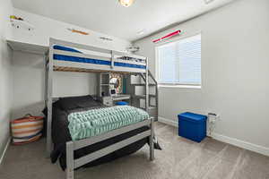 Bedroom featuring baseboards and carpet