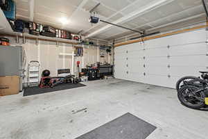 Garage with freestanding refrigerator and a garage door opener
