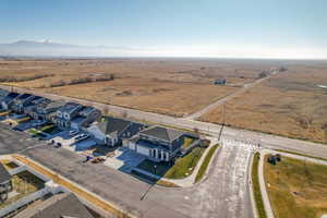 Aerial view of sparsely populated area featuring nearby suburban area and a mountainous background