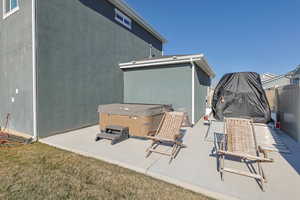 View of patio with a hot tub