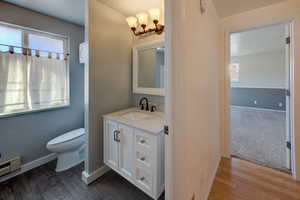 Bathroom with vanity, natural light, and dark wood-style flooring