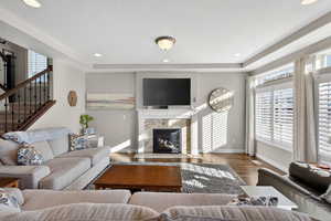 Living room with plenty of natural light, recessed lighting, a fireplace, wood finished floors, and a textured ceiling