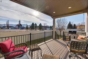 Balcony featuring a mountain view, an outdoor living space, and a residential view