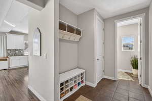 Mudroom with radiator and a textured ceiling