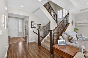 Foyer entrance featuring healthy amount of natural light, dark wood-type flooring, recessed lighting, a textured ceiling, and stairs