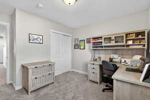Bedroom with a textured ceiling and light colored carpet