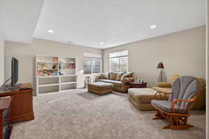 Loft/Living room with carpet flooring, a textured ceiling, and recessed lighting