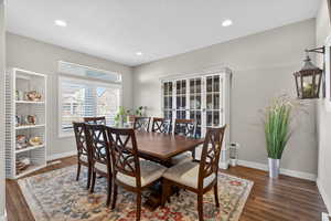 Dining area with dark wood-style floors, recessed lighting, and a textured ceiling