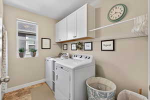Laundry area with cabinet space and washing machine and dryer