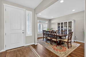 Entryway with dark wood finished floors and recessed lighting