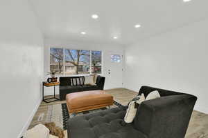 Living room with recessed lighting and light wood finished floors