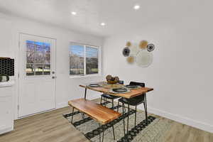 Dining room featuring a textured ceiling, light wood-style flooring, and recessed lighting