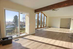 Unfurnished living room with light wood-type flooring and a ceiling fan