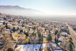 Aerial overview of property's location featuring nearby suburban area and mountains