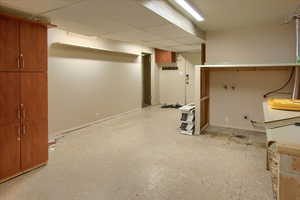 Finished below grade area featuring light floors and baseboards