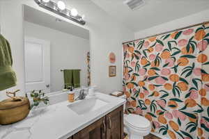 Bathroom with vanity and curtained shower